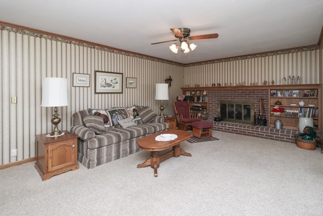 carpeted living room featuring baseboards, a brick fireplace, wallpapered walls, and ceiling fan