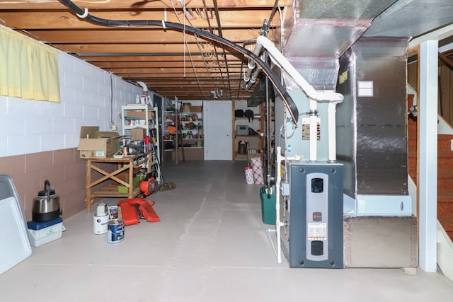 unfinished basement with heating unit and concrete block wall