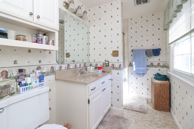 full bath featuring an enclosed shower, toilet, wallpapered walls, and vanity