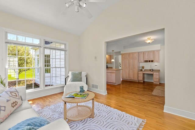 sitting room featuring lofted ceiling, visible vents, light wood finished floors, and plenty of natural light