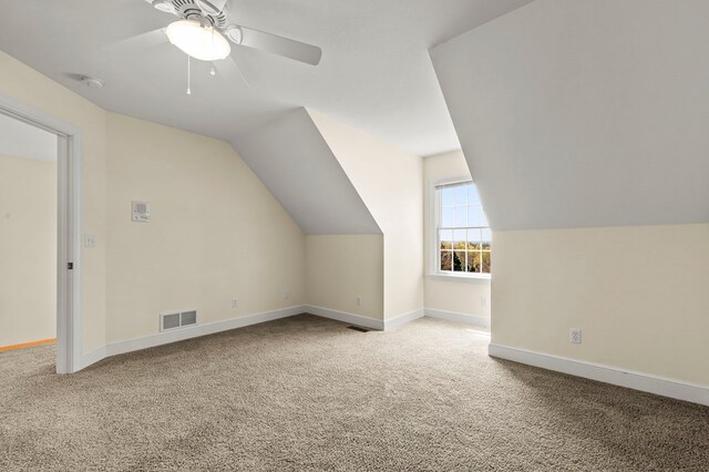 bonus room featuring vaulted ceiling, visible vents, a ceiling fan, carpet floors, and baseboards