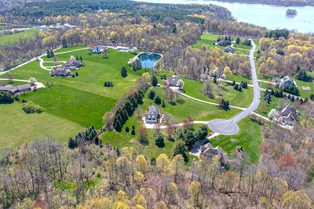 bird's eye view with a forest view and a water view