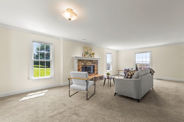carpeted living room featuring a fireplace, crown molding, and baseboards