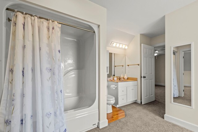 bathroom with shower / bath combination with curtain, baseboards, vanity, and toilet