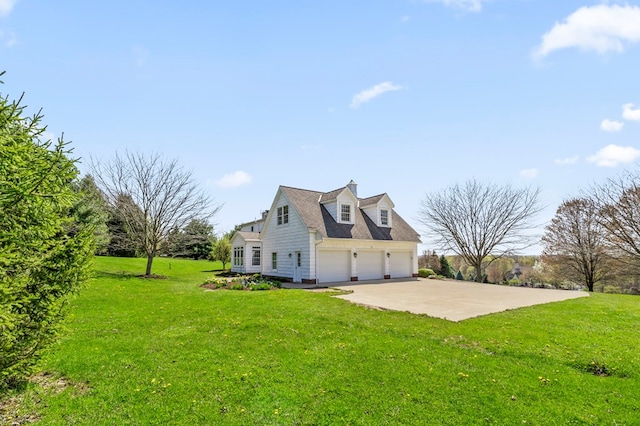 view of side of property featuring a lawn and concrete driveway