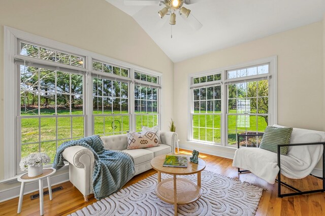 sunroom / solarium with vaulted ceiling, a ceiling fan, and a wealth of natural light