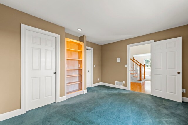 unfurnished bedroom featuring visible vents, dark colored carpet, baseboards, and recessed lighting