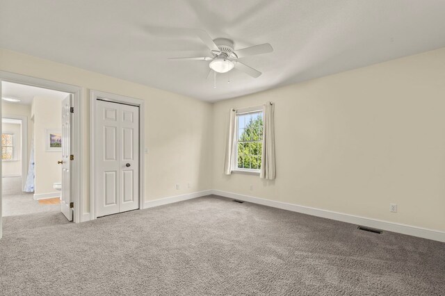 unfurnished bedroom with baseboards, carpet flooring, and visible vents