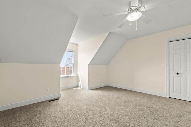 bonus room with ceiling fan, baseboards, lofted ceiling, carpet flooring, and visible vents