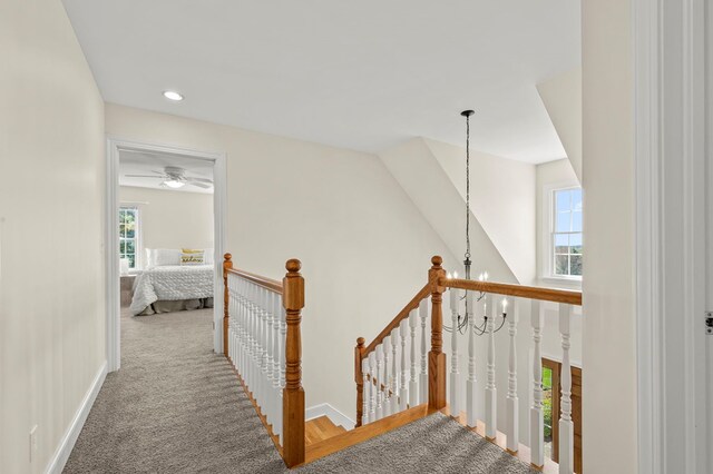 hall with recessed lighting, carpet floors, baseboards, and an upstairs landing