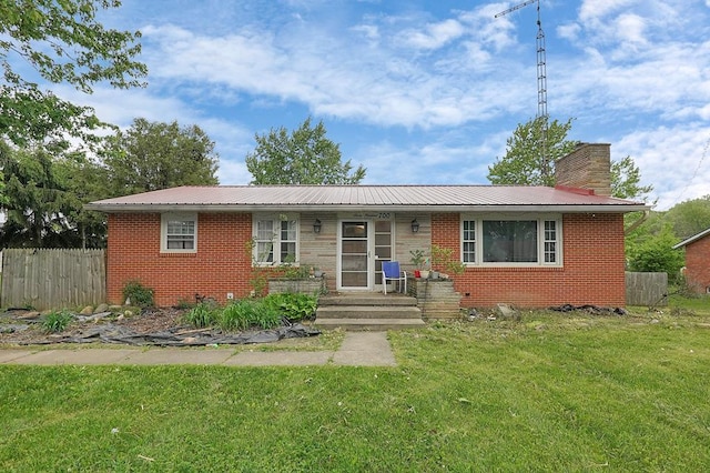 700 N Henry St, Crestline, OH 44827 - view of front of home featuring brick siding, metal roof, and a chimney