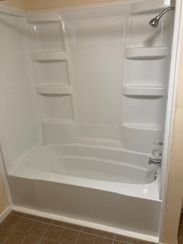 bathroom with tile patterned floors and shower / bath combination