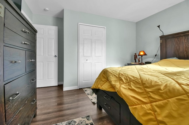 bedroom with a closet and dark hardwood / wood-style flooring