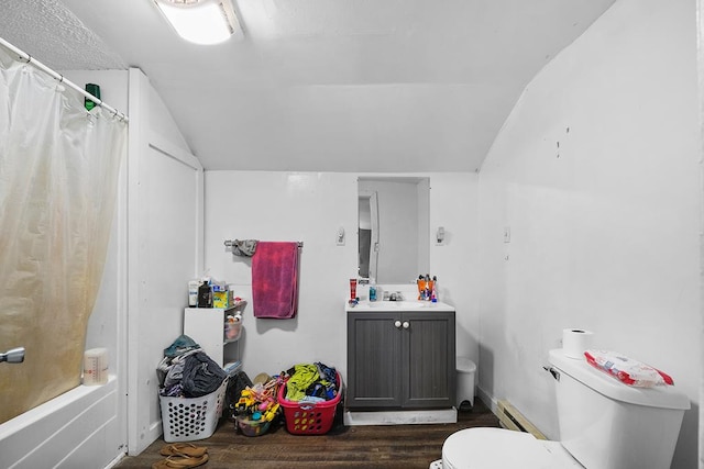 full bathroom featuring lofted ceiling, toilet, shower / bath combo, vanity, and wood finished floors