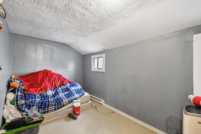 bedroom with baseboards, lofted ceiling, carpet, a textured ceiling, and a baseboard heating unit