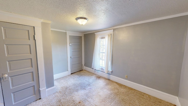 unfurnished bedroom featuring a closet, light carpet, crown molding, and a textured ceiling