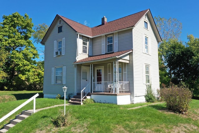 view of front of property featuring a front yard and a porch