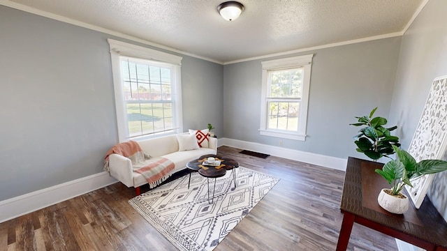 living room with a wealth of natural light, dark hardwood / wood-style flooring, and crown molding