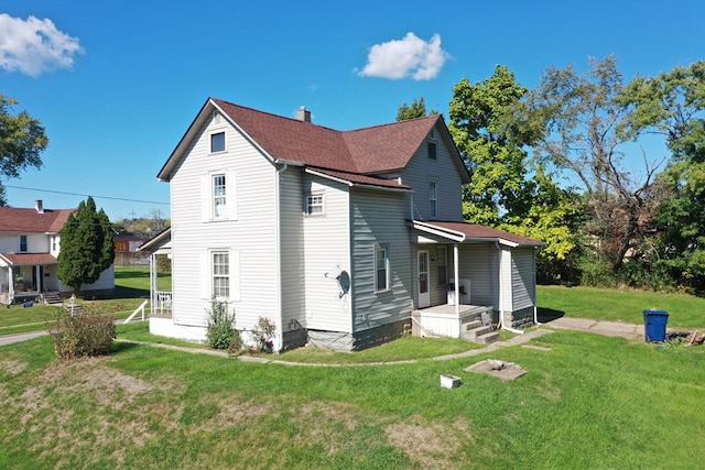 back of property with a yard