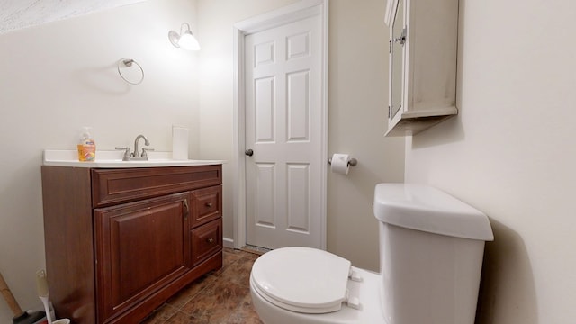 half bathroom featuring vanity and toilet