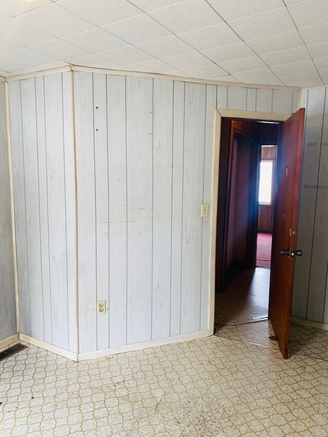 empty room featuring wooden walls