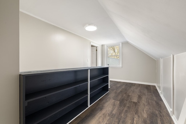 bonus room featuring baseboards, dark wood-style flooring, and lofted ceiling