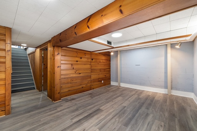 additional living space featuring wood finished floors, visible vents, stairs, and baseboards
