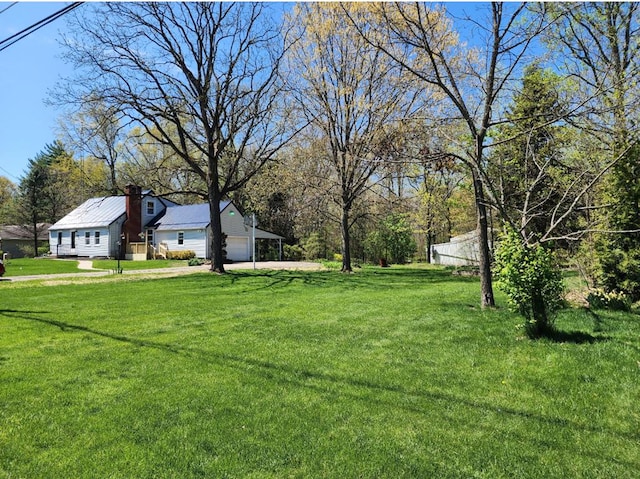 view of yard with driveway and a garage