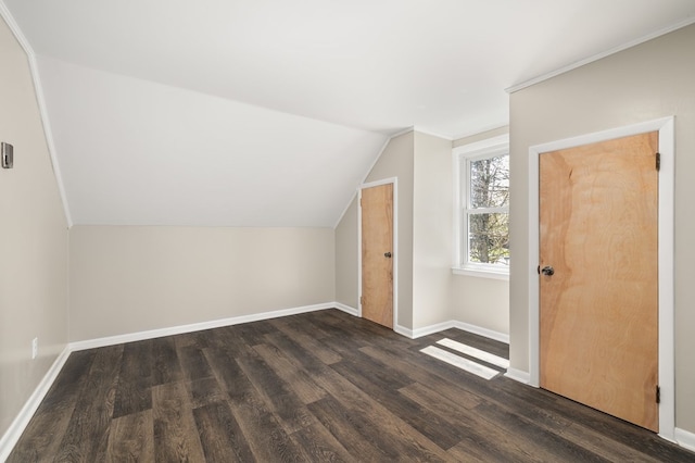 bonus room with wood finished floors, vaulted ceiling, and baseboards