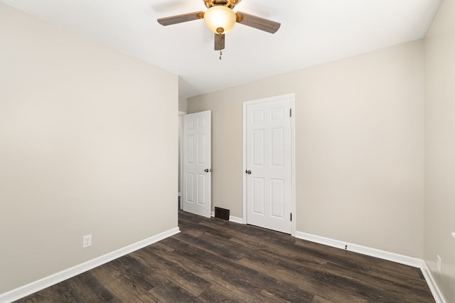 unfurnished bedroom with baseboards, a ceiling fan, and dark wood-style flooring