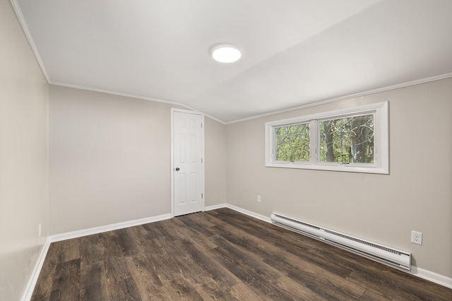 empty room featuring a baseboard heating unit, dark wood finished floors, ornamental molding, and baseboards