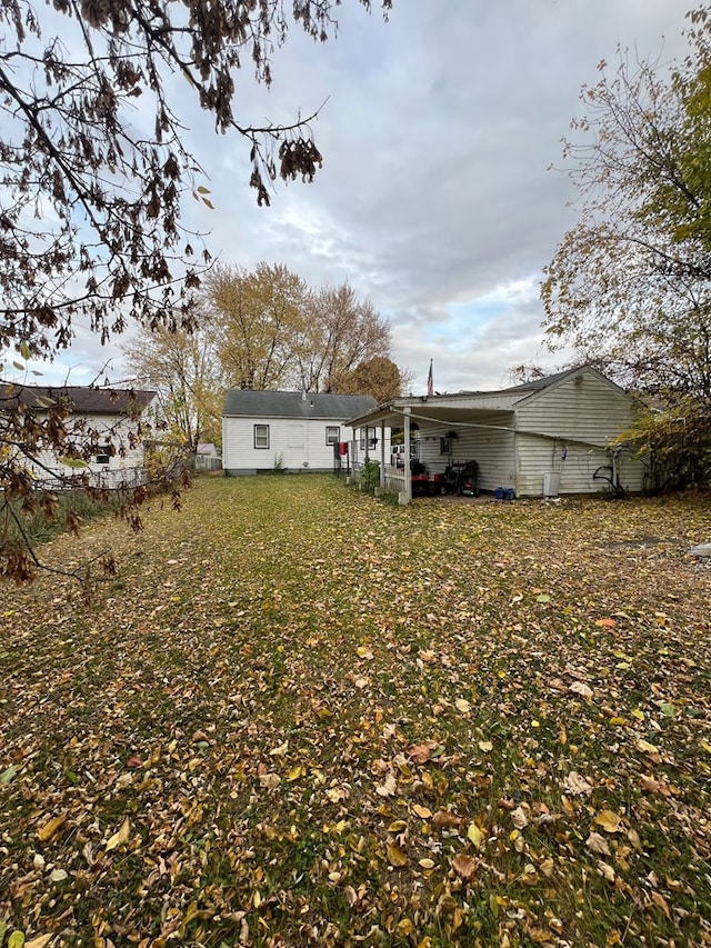 back of property featuring a lawn