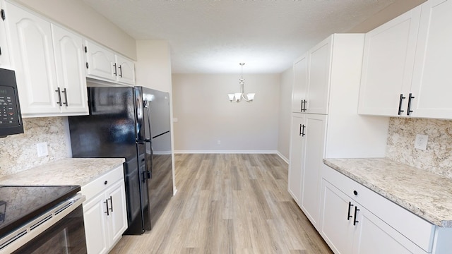 kitchen with white cabinetry, light countertops, baseboards, a chandelier, and light wood-style flooring