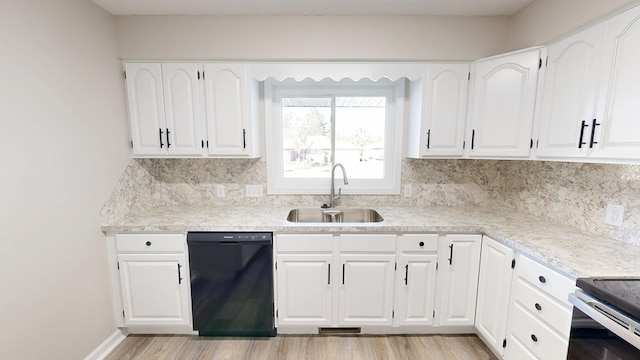 kitchen featuring dishwasher, light wood-style flooring, a sink, and decorative backsplash