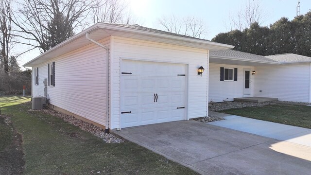 exterior space featuring driveway, a garage, central air condition unit, and a lawn