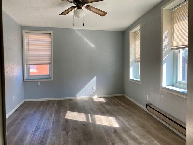 unfurnished room featuring wood-type flooring, a textured ceiling, a baseboard radiator, and ceiling fan