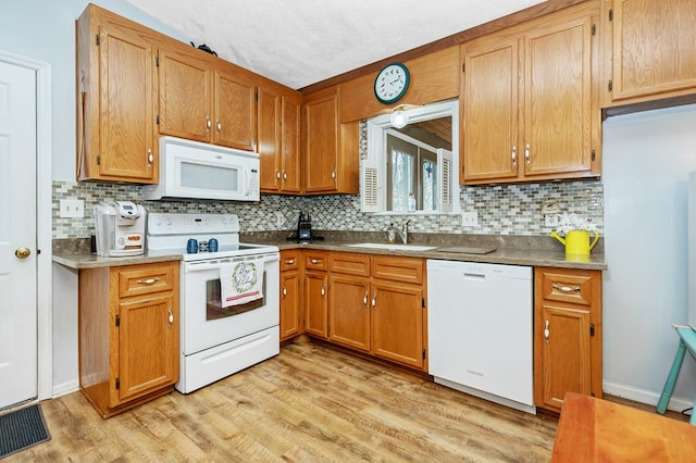 7326 State Route 19 Unit U8 L264-265, Mount Gilead, OH 43338 - kitchen featuring white appliances, tasteful backsplash, light wood-type flooring, and brown cabinets