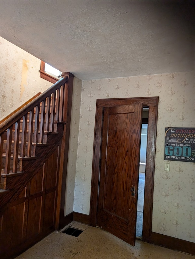 foyer with a textured ceiling