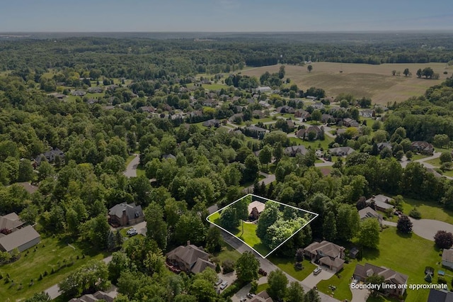 2313 Woodland Park Dr, Ontario, OH 44903 - aerial view of property and surrounding area featuring property boundaries highlighted and a heavily wooded area