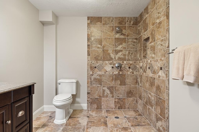 2313 Woodland Park Dr, Ontario, OH 44903 - bathroom featuring tiled shower, vanity, and a textured ceiling