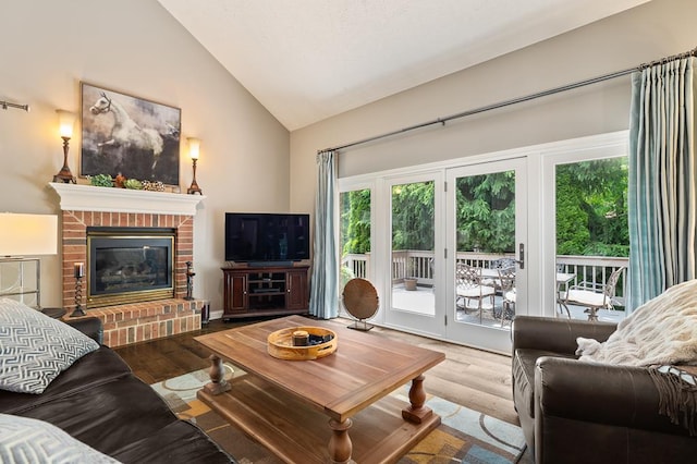 2313 Woodland Park Dr, Ontario, OH 44903 - living area featuring wood finished floors, healthy amount of natural light, high vaulted ceiling, and a fireplace