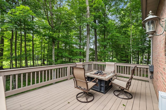 2313 Woodland Park Dr, Ontario, OH 44903 - wooden deck with an outdoor fire pit and view of scattered trees