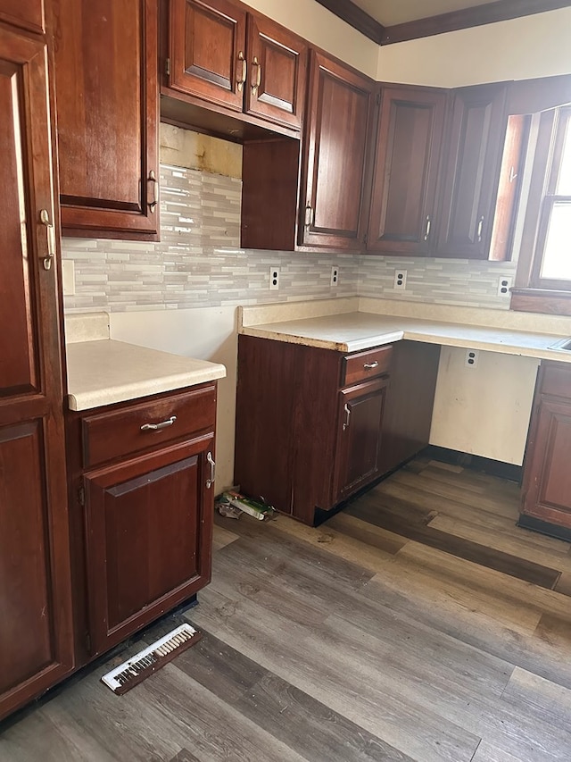 kitchen featuring dark wood finished floors, light countertops, visible vents, and tasteful backsplash