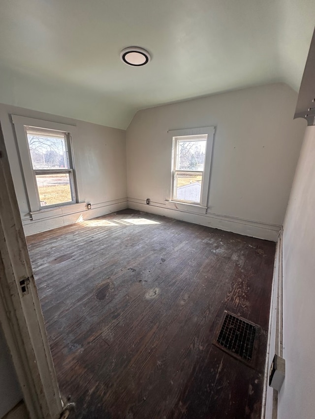 bonus room with visible vents, lofted ceiling, and wood-type flooring