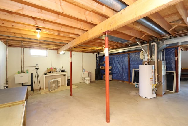 below grade area featuring a sink and water heater