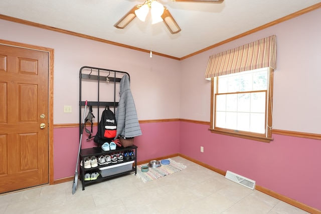 interior space with visible vents, ceiling fan, baseboards, and ornamental molding