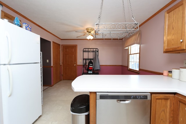 kitchen featuring ornamental molding, stainless steel dishwasher, freestanding refrigerator, a peninsula, and light countertops