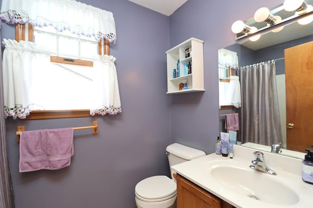 full bathroom featuring toilet, vanity, and a shower with curtain