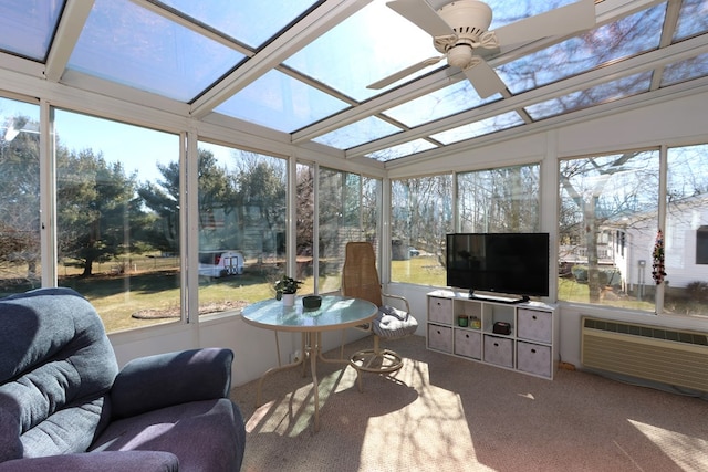 sunroom featuring plenty of natural light, an AC wall unit, and ceiling fan