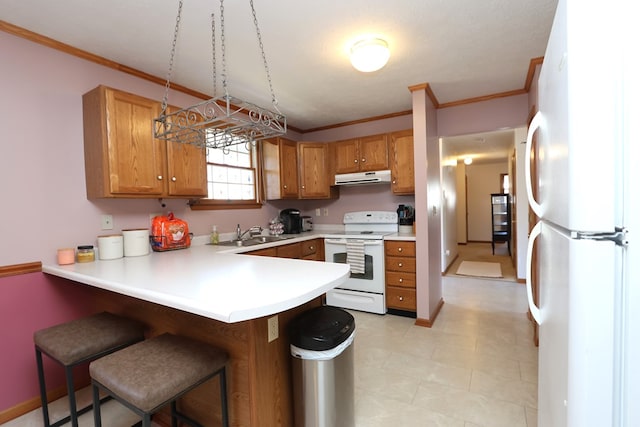 kitchen with a sink, white appliances, a peninsula, exhaust hood, and brown cabinetry